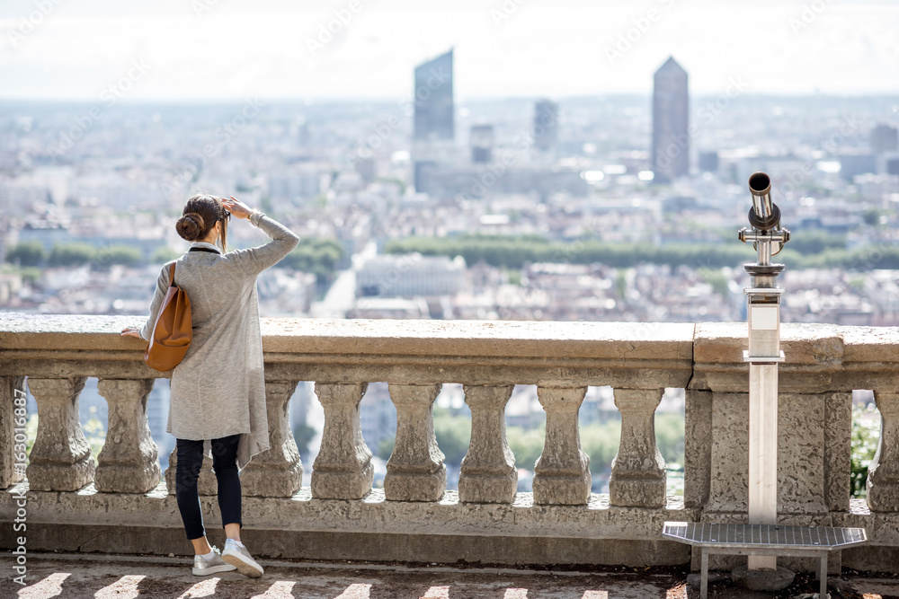 Woman enjoying great view on Lyon city with skyscrapers during the morning in France