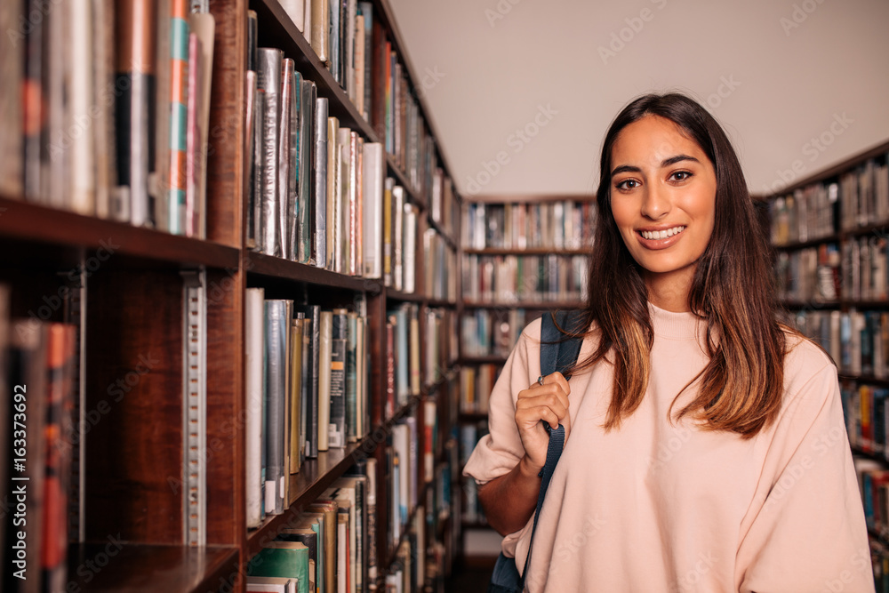 Young student standing in the library
