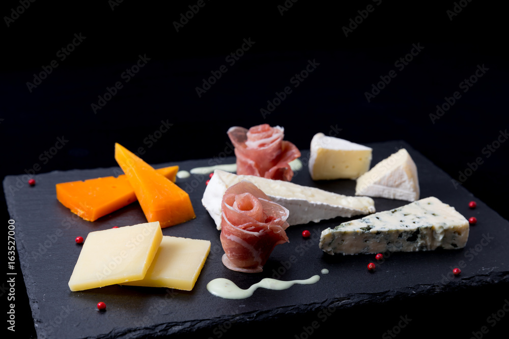 cheese appetizer on black background
