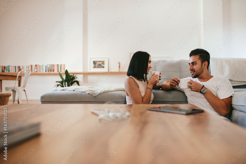 Young couple having coffee at home