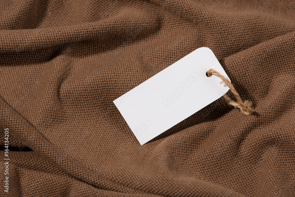 Shirt price tag. Rectangular tag is attached to a sweater