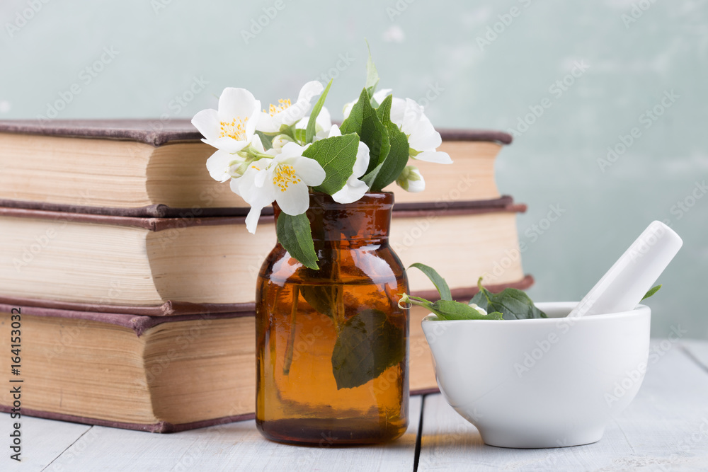 Spa concept - making essential oil with jasmine flowers