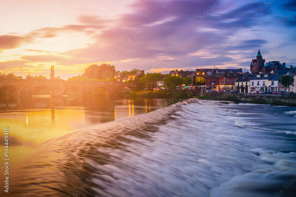 The River Nith and old bridge at sunset in Dumfries, Scotland, UK.