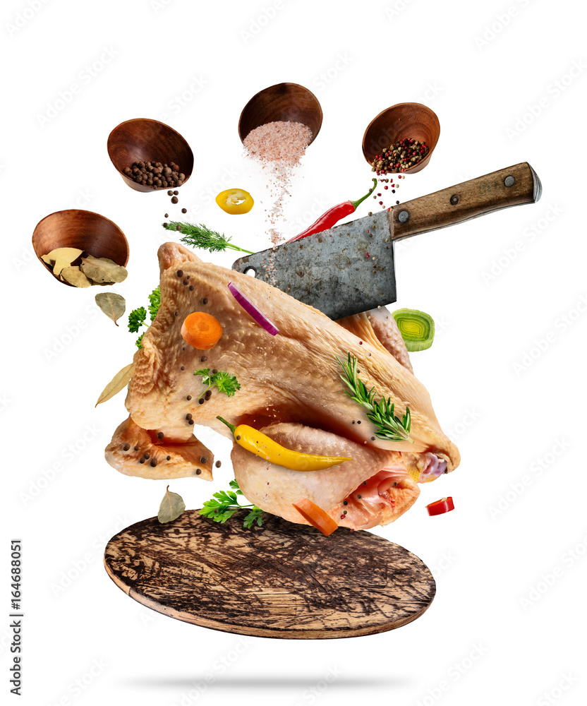 Whole raw chicken with ingredients, food preparation concept