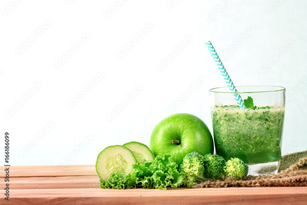  Healthy fresh  green smoothie juice in the glass bottle on wooden table for healthy detox and diet 