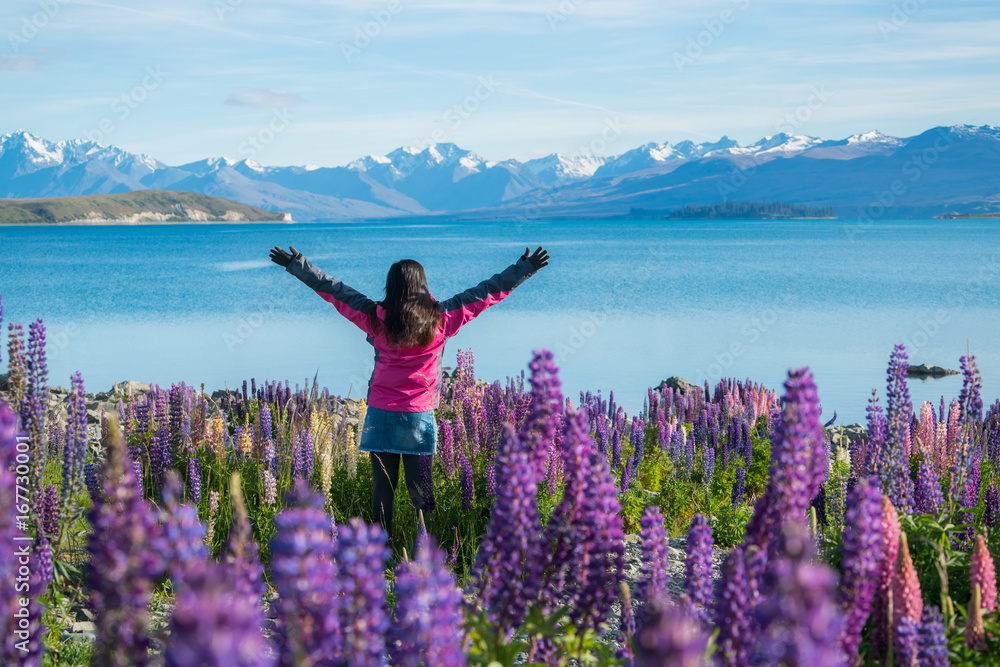 Tourist woman at lake Tekapo, New Zealand