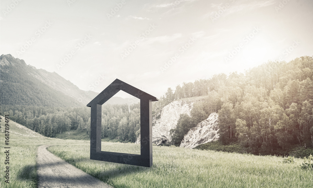 Conceptual background image of concrete home sign on green grass