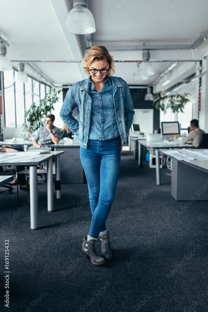 Businesswoman standing in office and looking down
