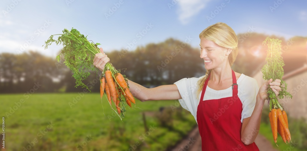 微笑的年轻女子拿着胡萝卜的合成图