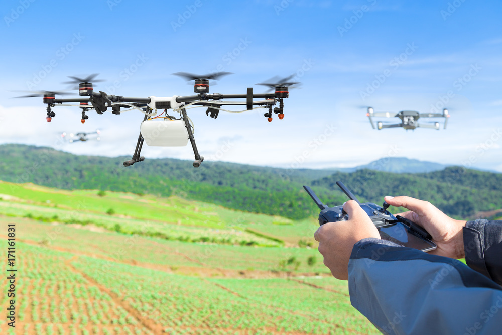 Farmer control agriculture drone fly to sprayed fertilizer on the lettuce field