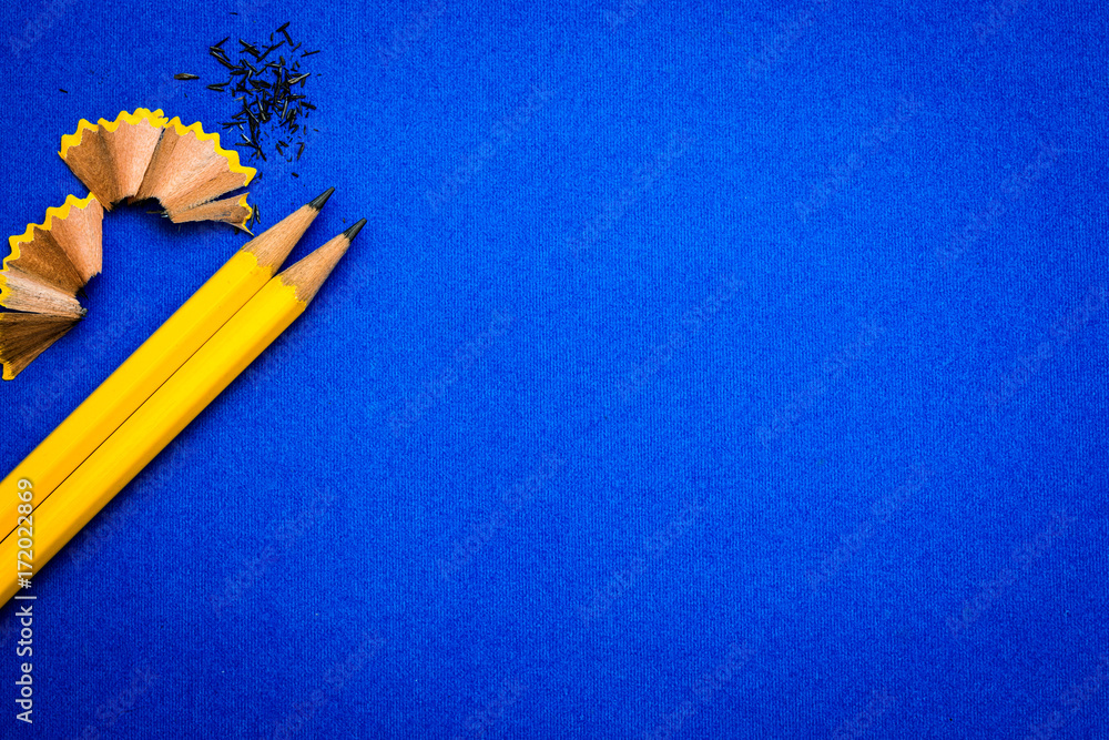 亮蓝色背景上的黄色铅笔，创意创新理念符号或教育理念