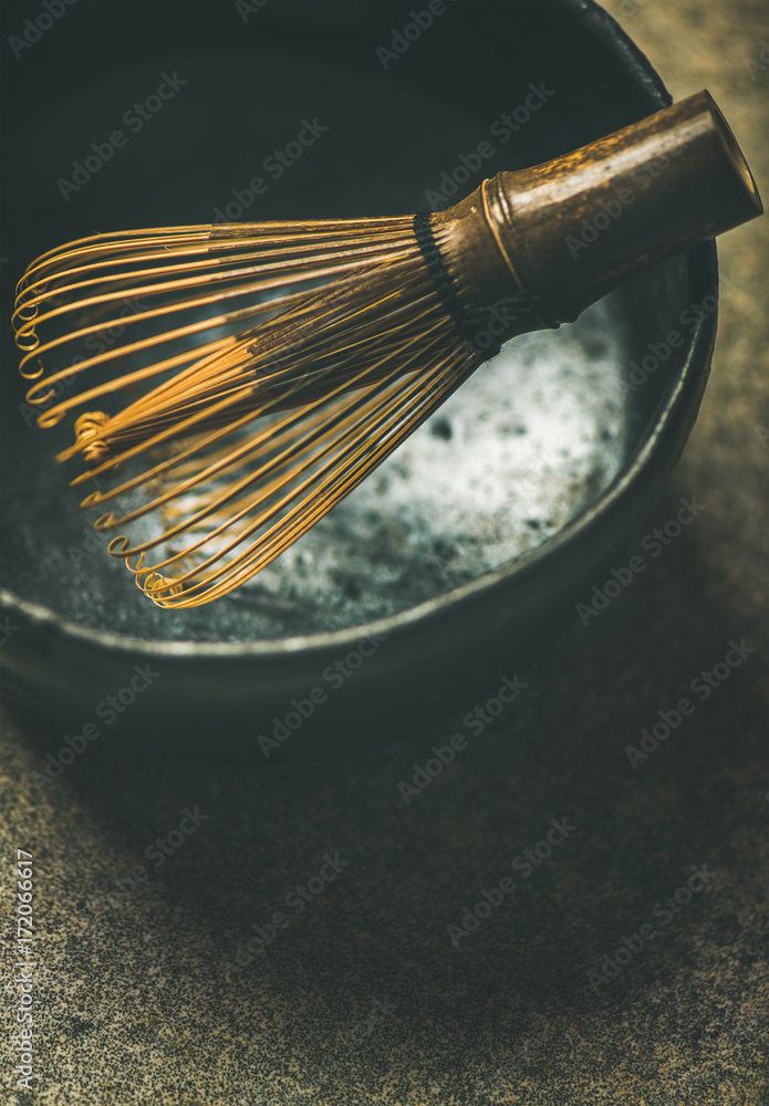 Close-up of traditional Japanese Chasen whisk and dark bowl for brewing Matcha tea, copy space