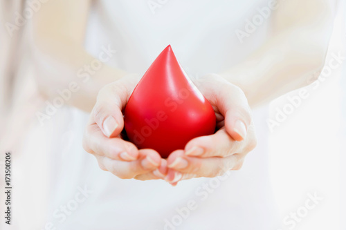 Hands holding a red blood
