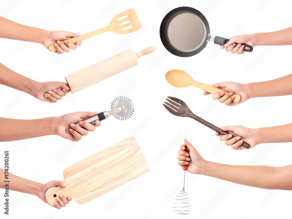 Chefs hands holding kitchen utensils/many equipments for food isolated on white background