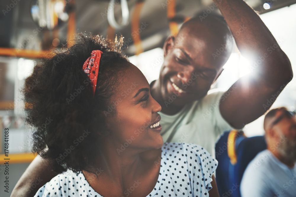 一对深情的非洲年轻夫妇一起站在公交车上