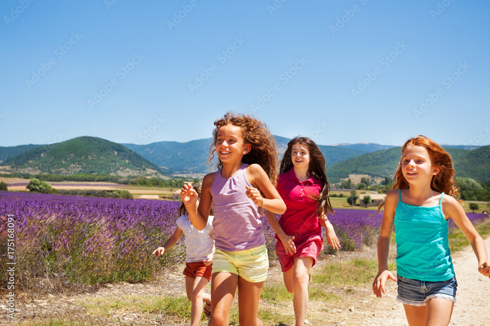 Happy playmates running through lavender field