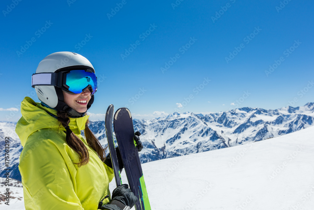 Happy young woman skier enjoying sunny weather in Alps