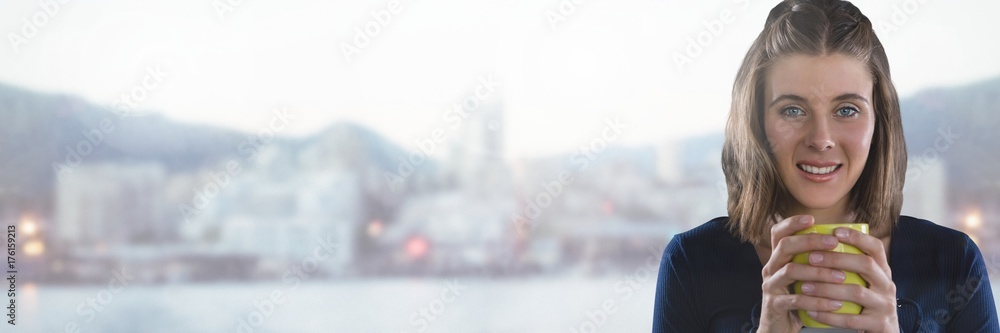 Woman holding cup with cold city