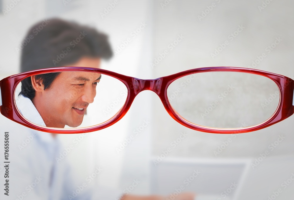 Composite image of happy man using laptop while having a coffee
