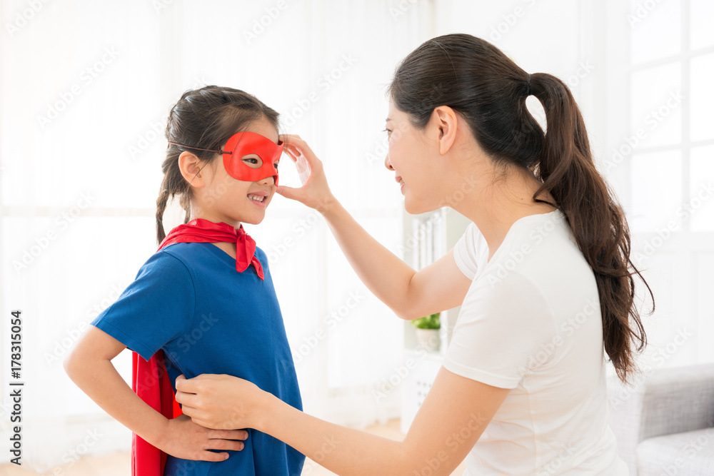 sweet girl kid wearing red cloak play as superhero