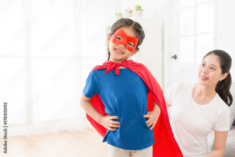 little kid girl face to camera wearing red cloak