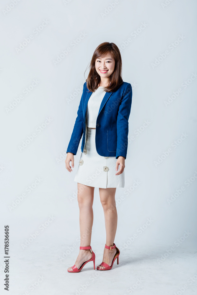 asian woman in blue suit happiness action pose in studio isolate white background