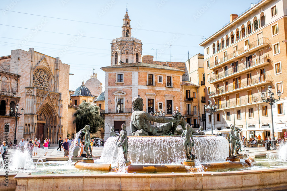 View in the Virgen square with cathedral and fountain in the centre of Valencia city during the sunn
