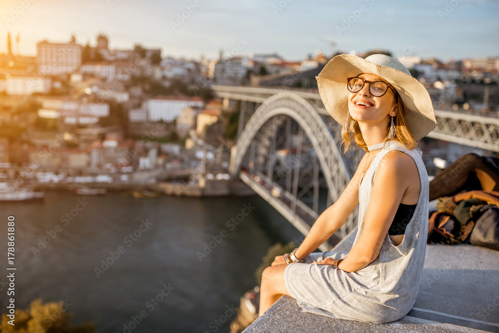 Lifestyle portrait of a young woman tourist enjoying great view on the old town and river in Porto c