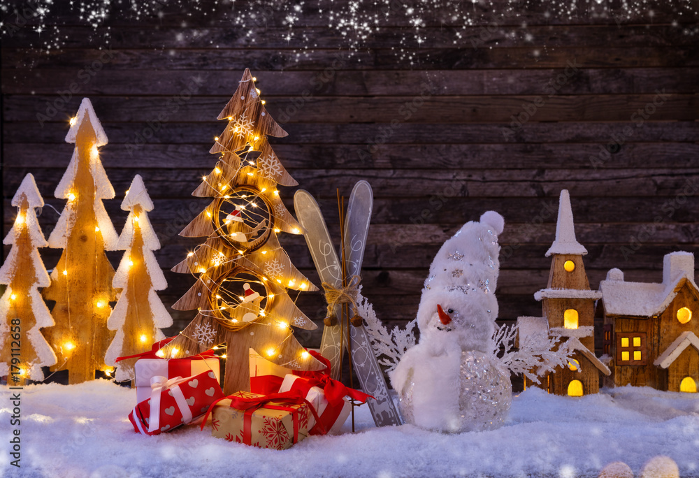 圣诞背景，带照明的木制村庄和带树的雪人