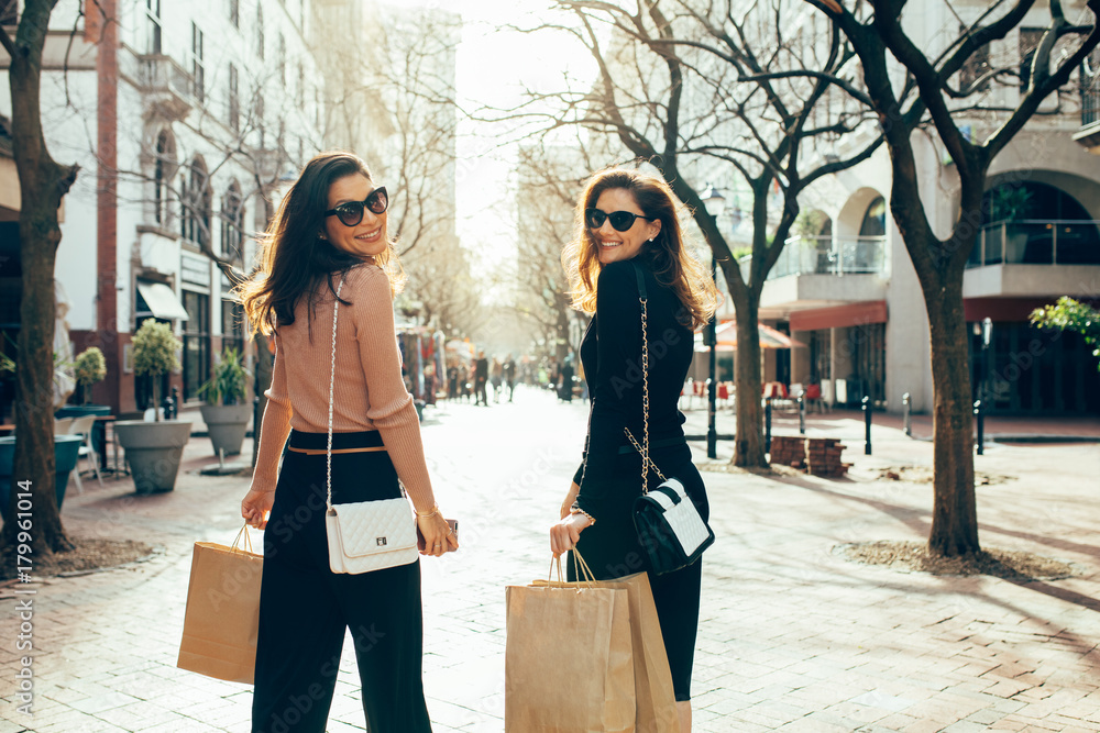 Friends having fun on a shopping spree in the city
