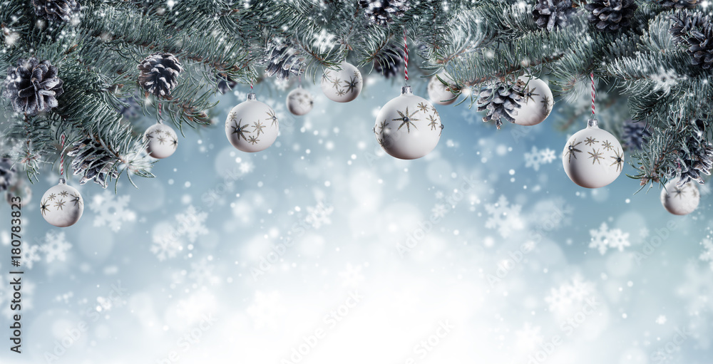 Christmas background with fir tree branches, glass balls and cones with snow flakes
