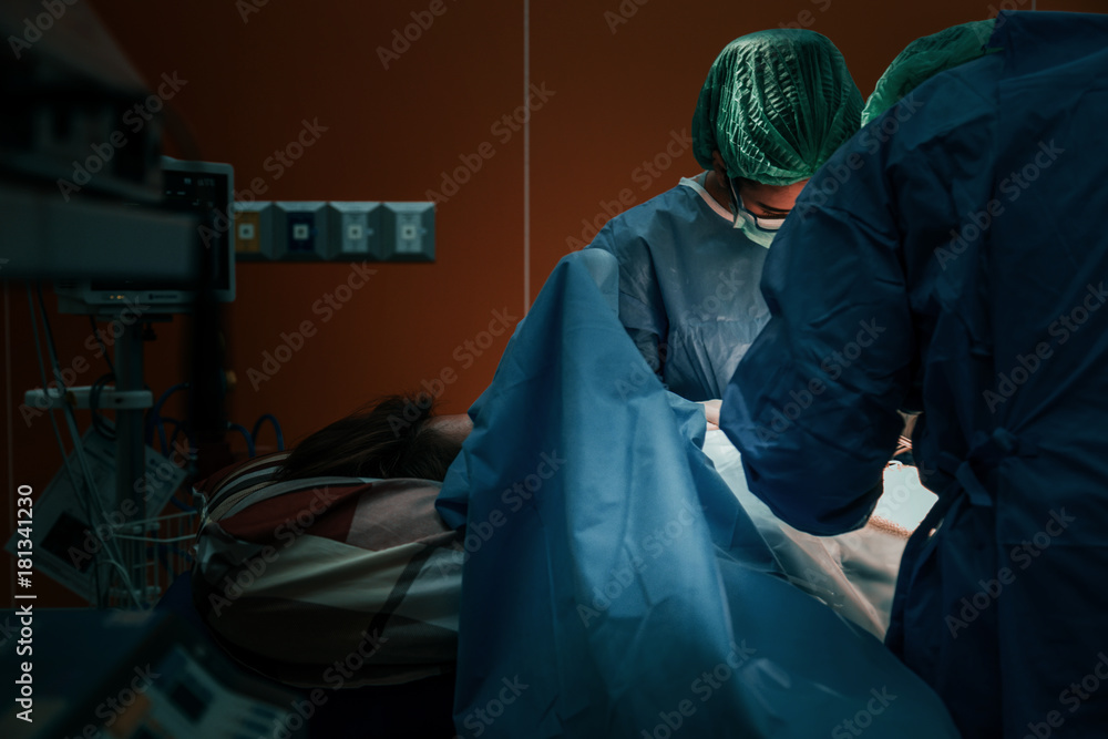 doctor and assistance Medical team performing surgery on a patient with focus and stressful moment