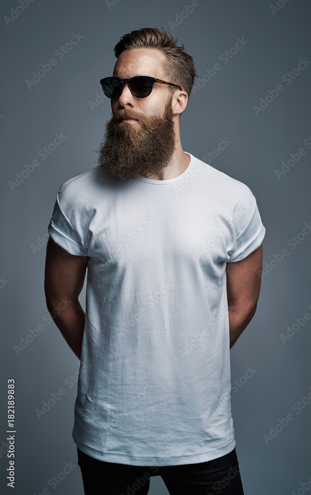 Cool young man with a long beard wearing sunglasses