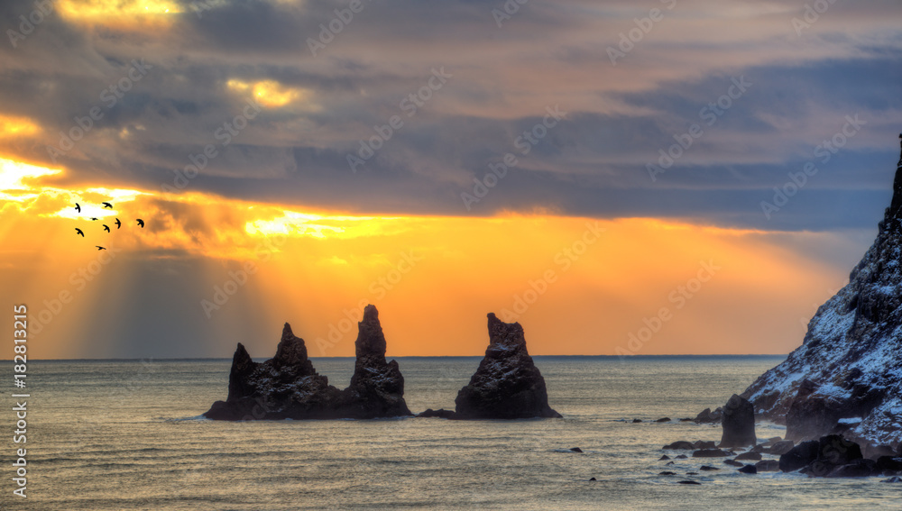 Amazing spiked rocks in ocean, Reynisfjara beach near Vik town, Iceland