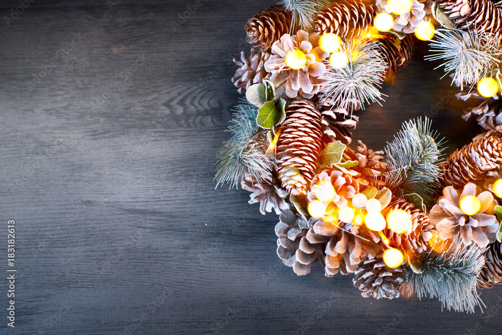 Christmas vintage background. Holiday evergreen tree wreath decorated on dark wooden table