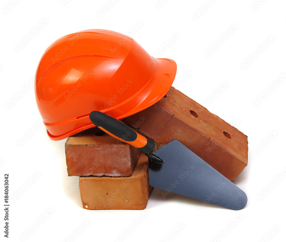 Brick, red hard hat and tools