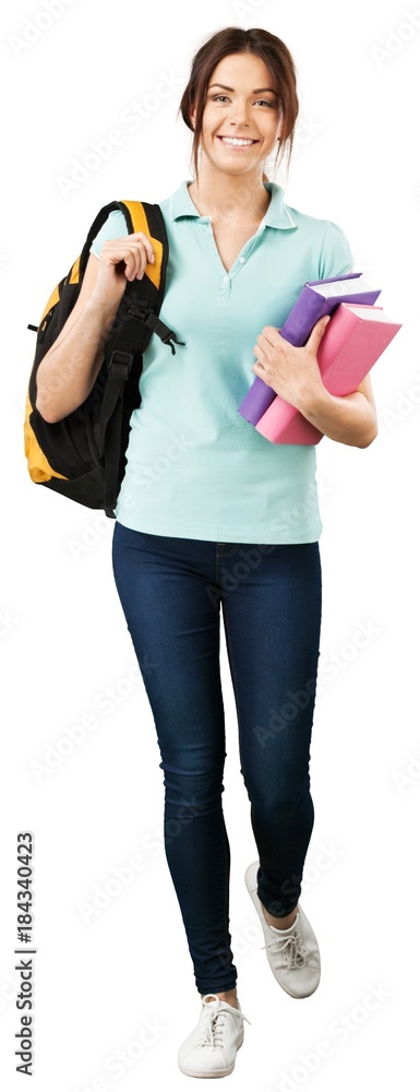 Teenage student girl with books going forward