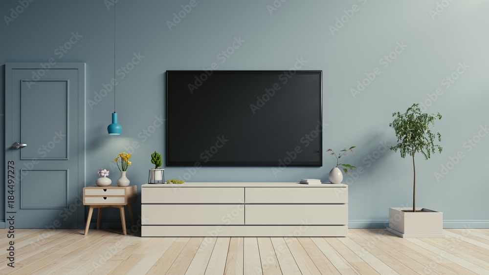 蓝色墙壁背景下现代客厅橱柜上的电视，三维渲染