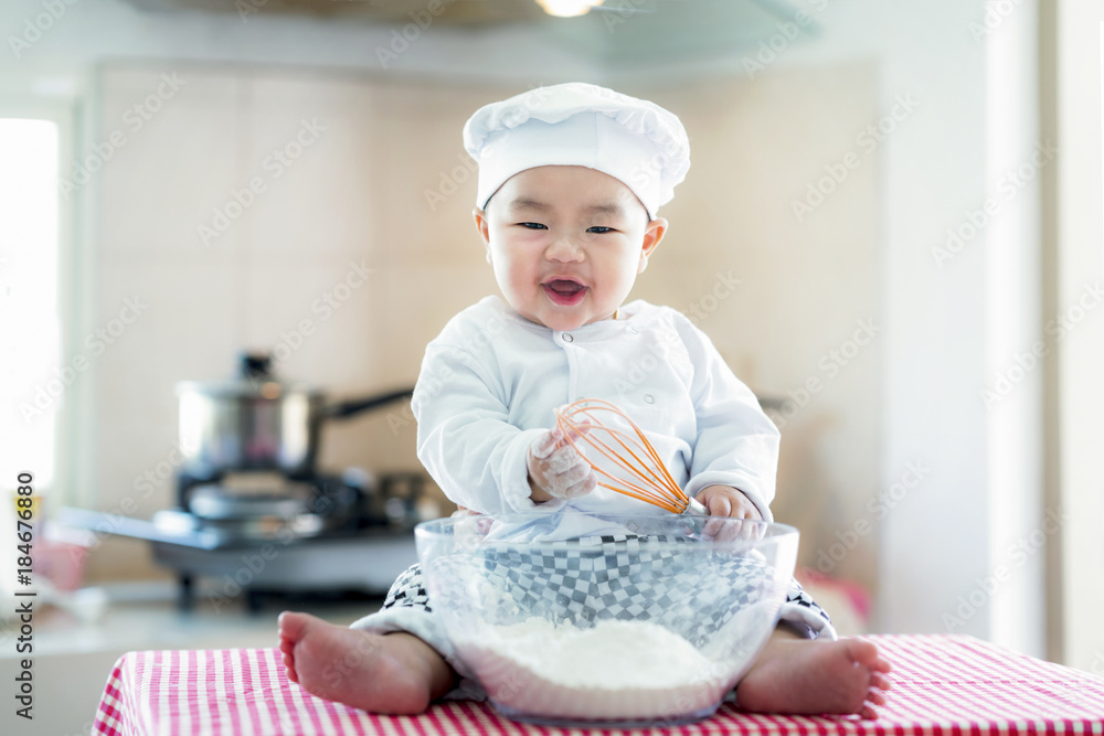 亚洲婴儿在厨房，新生儿对工作、职业、职业和梦想的概念。食物、烹饪，br