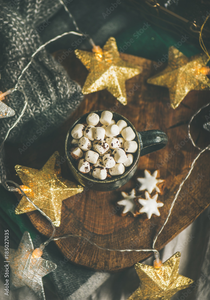 Christmas or New Year winter hot chocolate with marshmallows and gingerbread cookies over rustic woo