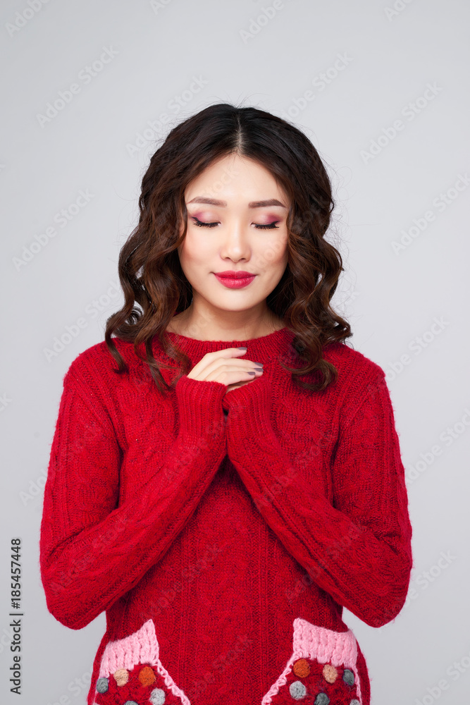 Portrait of Beautiful asian woman in warm clothing wishing