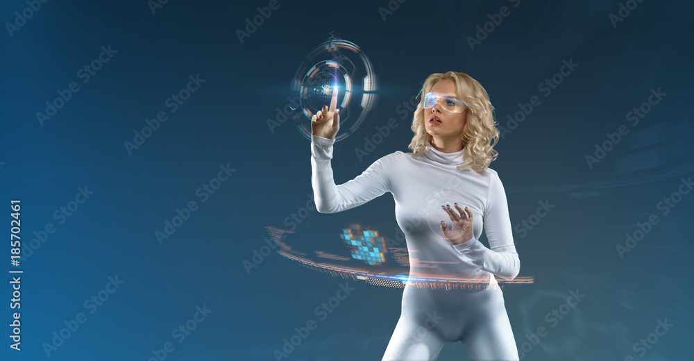 Attractive Blonde model in futuristic environment working with virtual hud interface
