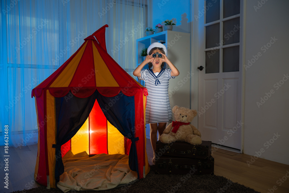 shocked kid girl sailor playing with tent at night