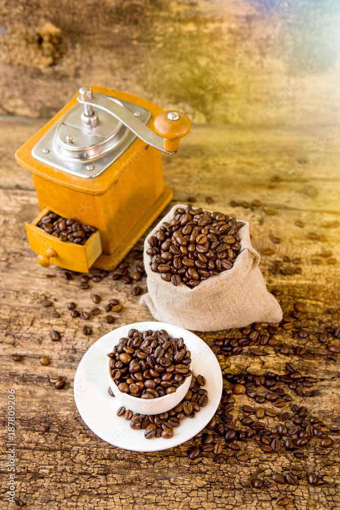 Cup of coffee beans. Coffee grinder and bag with coffee beans in the background. Coffee. Coffee bean