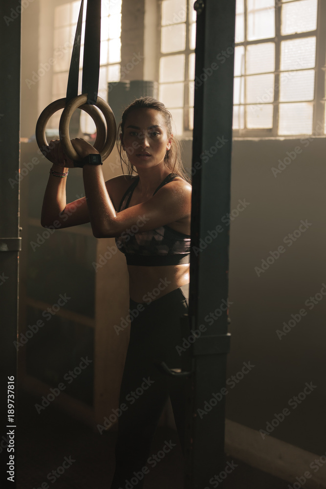 Woman working out on gymnast rings
