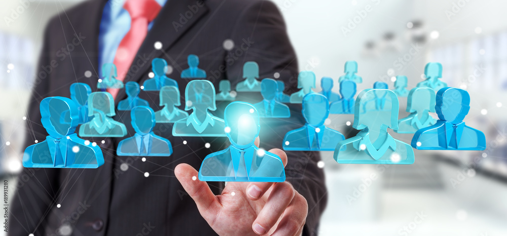 Businessman holding 3D rendering group of blue people