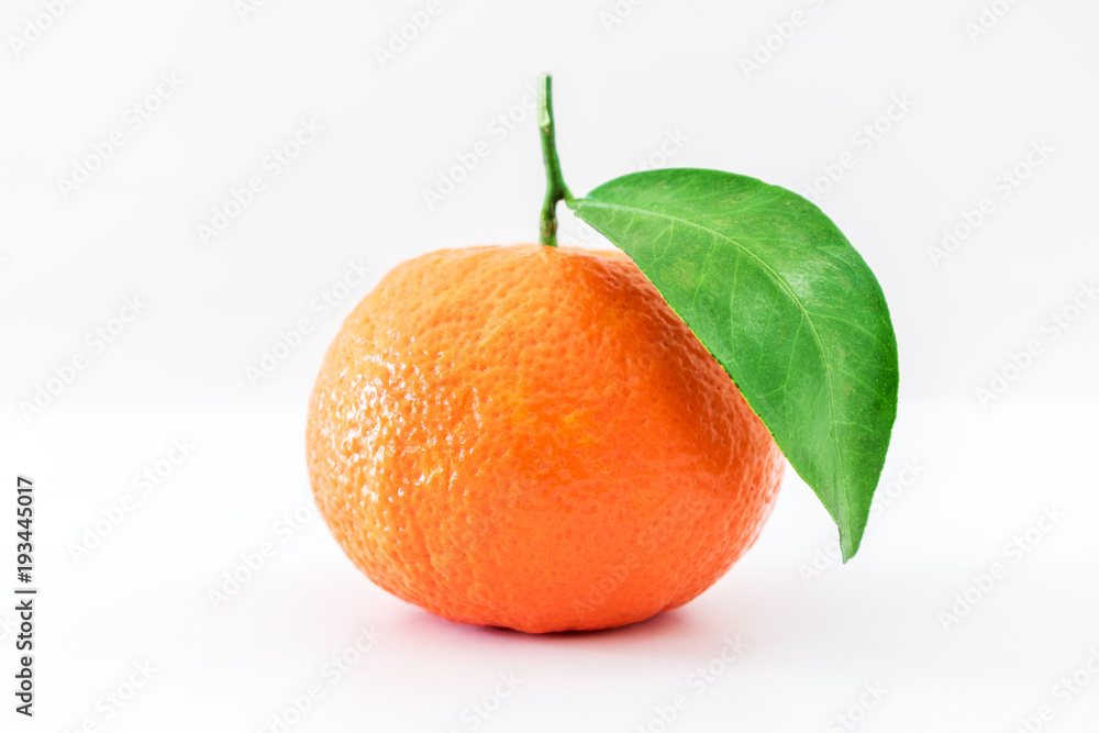 Mandarine or clementine with green leaf isolated on white background