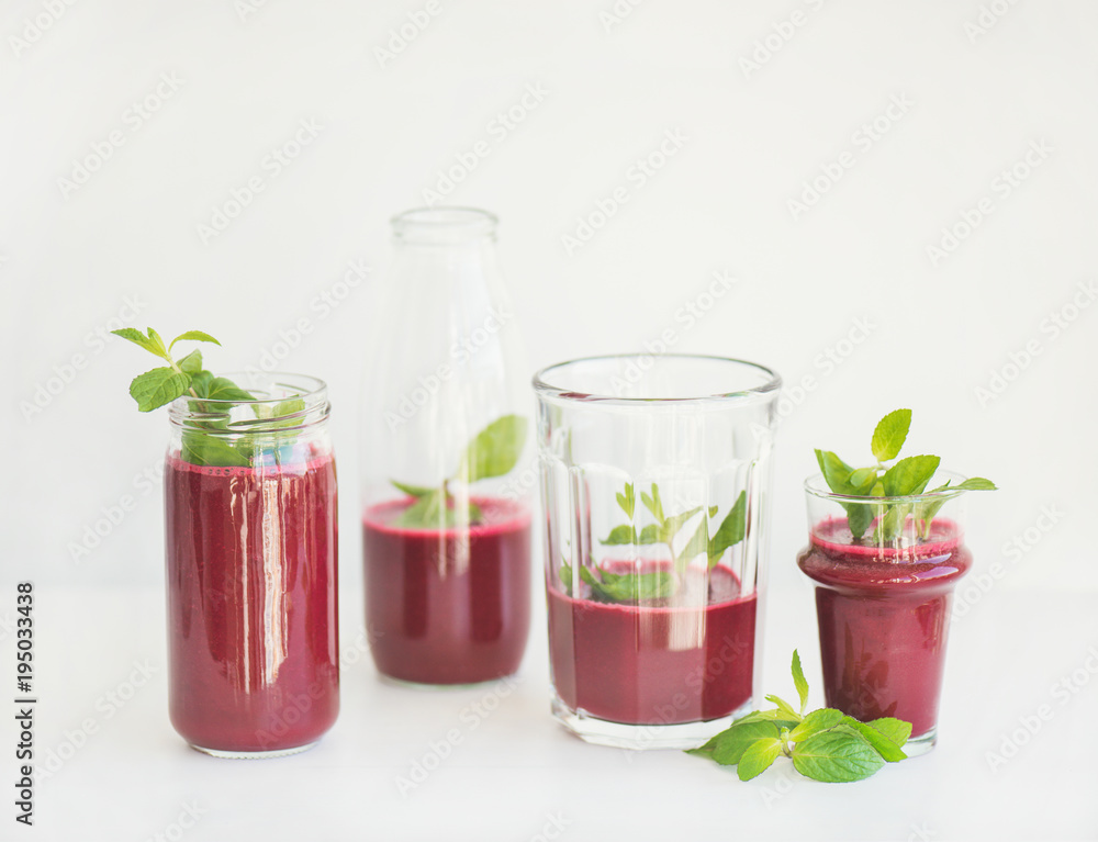 Fresh morning beetroot smoothie or juice in glasses with mint leaves, white background, copy space. 