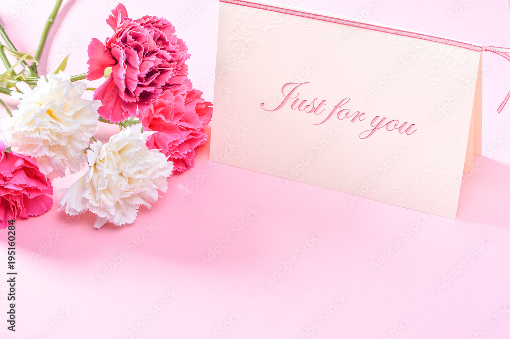 五月母亲节康乃馨花束，带礼品卡俯视图，空白文本，粉红色
