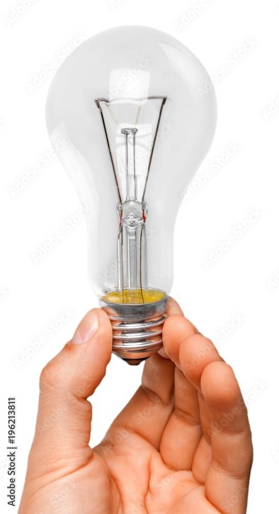 Hand holding light bulb isolated on white